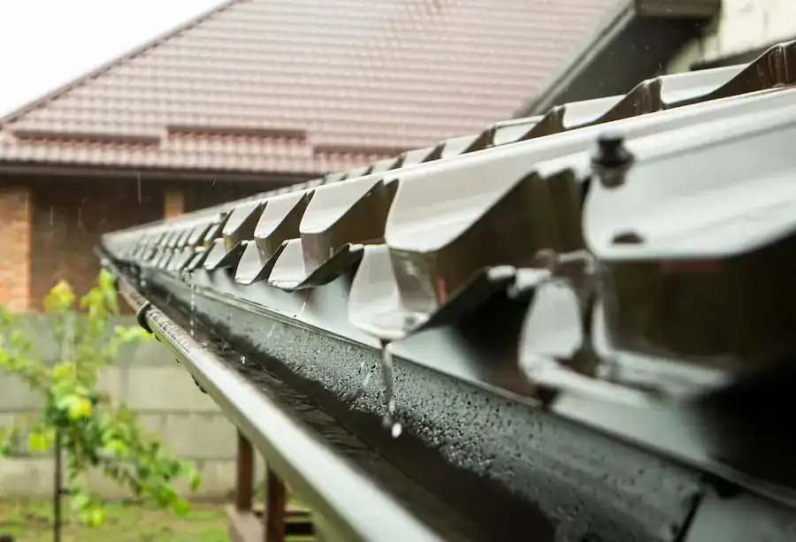Rain running off a roof into a gutter
