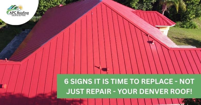 Red metal roof on house with green warning banner.