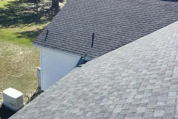 Roofing installation on residential homes with asphalt shingles.