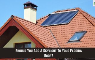 Solar panel installed on a residential roof with red tiles and skylight.