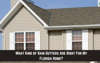 Gutter system installed on a beige house with white trim and a gable roof.