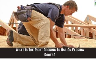 Roofing professional kneeling on a new roof frame during construction inspection.