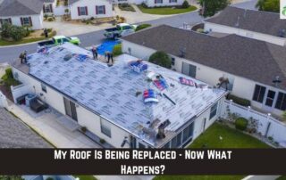 Roofers installing new roofing system on house during storm damage repair.