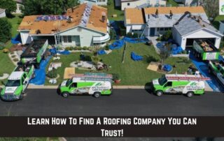 Roofers working on roof installation with safety gear and tools.