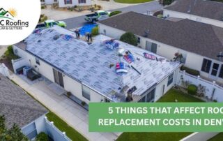 Aerial view of a residential roof installation with roofing crews working on a flat roof.