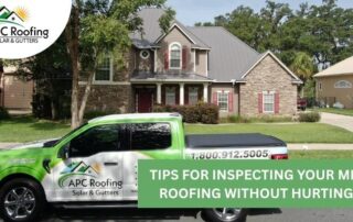 Crew inspecting a residential metal roof for storm damage and quality.