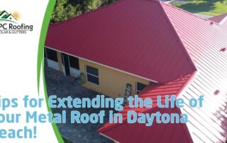 Aerial view of a house with a new red metal roof, showcasing roofing installation and storm damage r.