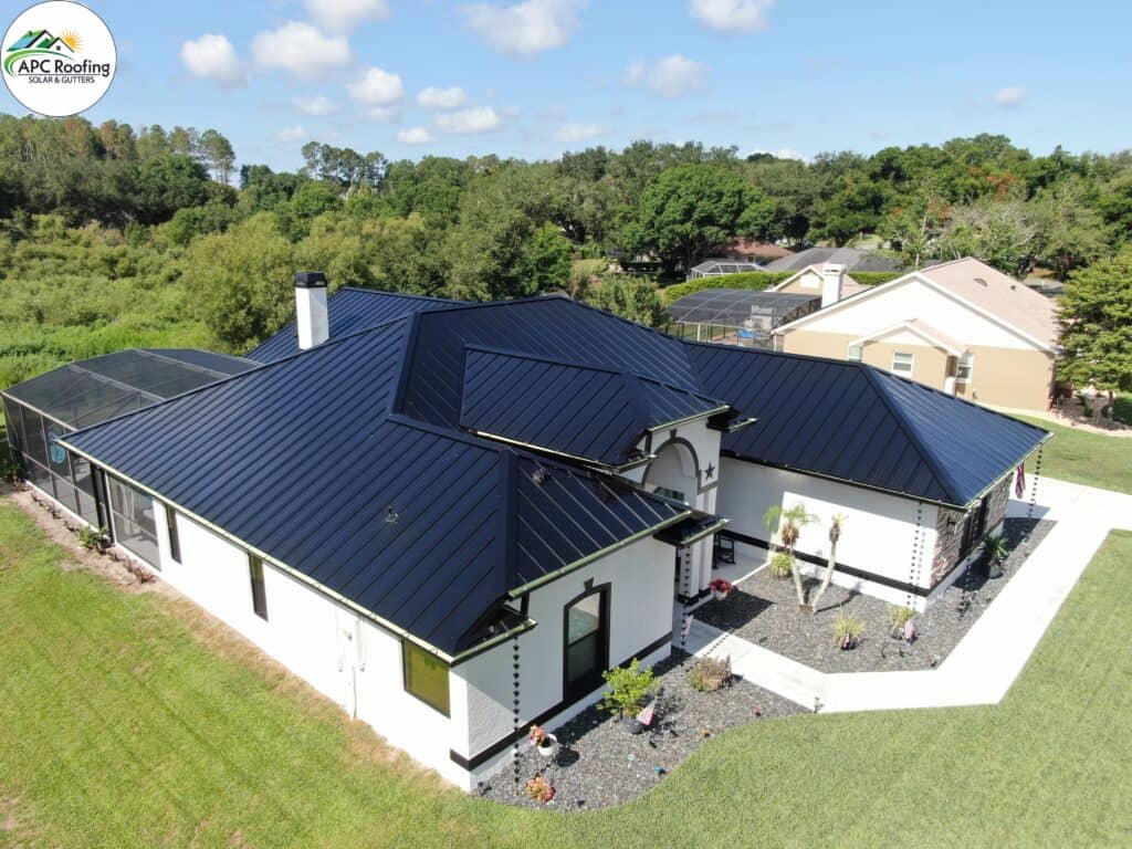 New black metal roof with multiple pitches and valleys on a white house in Clermont, Florida.