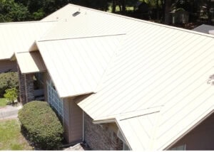 A metal roof with multiple vents and skylights on a residential building.