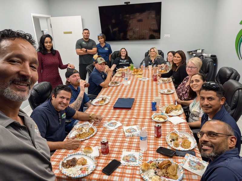 The APC Roofing team sharing a Thanksgiving lunch at the Clermont office